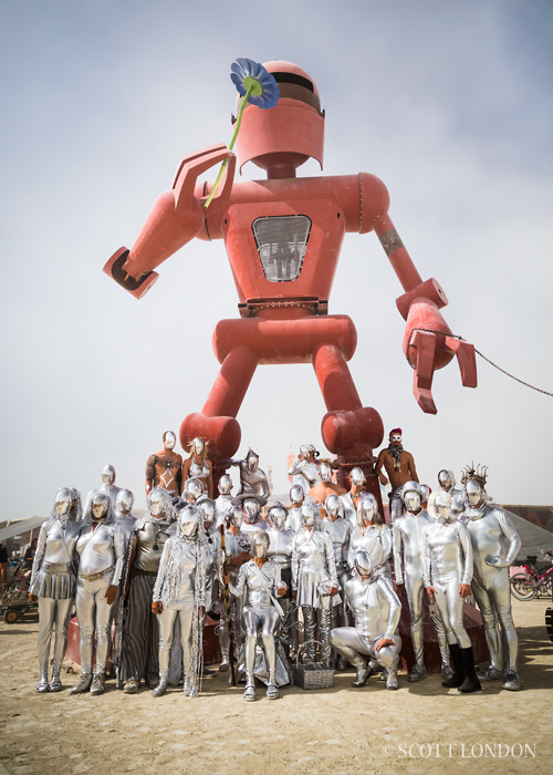 A group calling themselves the "Looking Glass Holes" gather under the installation "Becoming Human" by Christian Ristow at Burning Man 2015