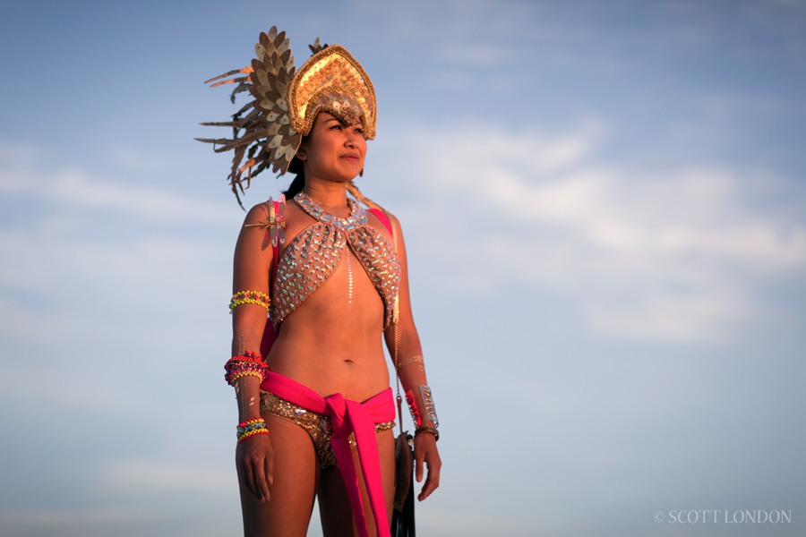 Julie, a burner from San Francisco, takes in the sunrise from the deep playa at Burning Man 2015. (Photo by Scott London)